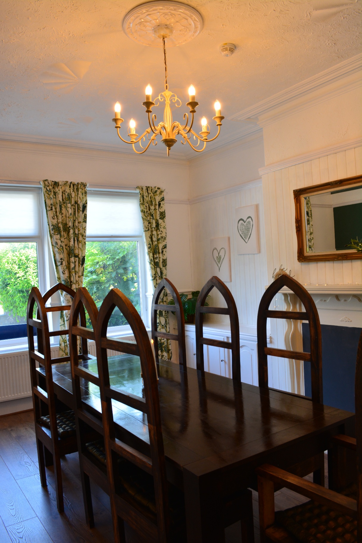 Dining room with chandelier and bay window